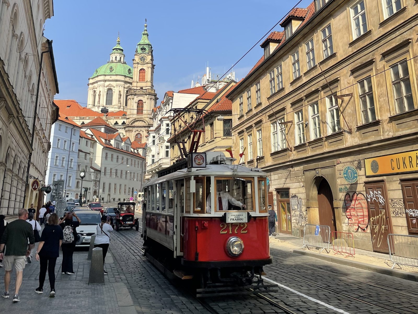 A red tram on a street in Prague